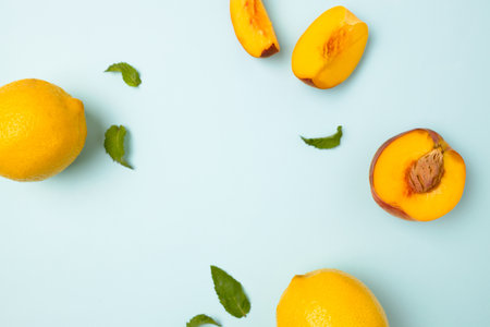 Fresh ripe peaches, lemons and green mint leaves on color blue background, flat layの写真素材