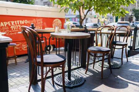 Street cozy stylish cafe with empty wooden vintage table and chairsの写真素材
