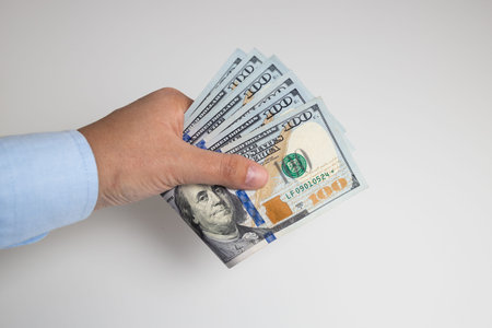 Woman hand with american money isolated on white background. Transaction, payment, salary and...