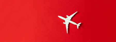 Creative composition with passenger plane on red background. Summer travelの写真素材