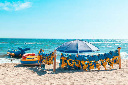 life jacket save your life. Yellow life jackets on the beach are ready to swim in the sea or ocean. Safe rafting and boat equipment.の写真素材