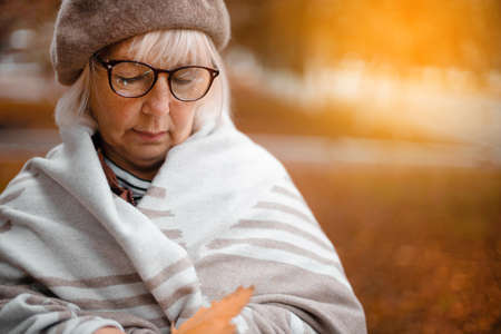 Happy 50 years old woman walking in the park in autumn. Fall season.の写真素材