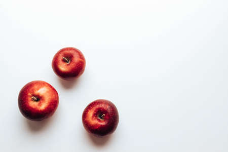 Three ripe juicy red rayal gala apples on grey backgroung. Top view. Autumn composition. Flat lay, top view, copy spaceの写真素材