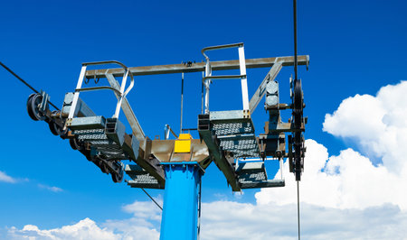 Pillar column support of the funicular over the mountains, cable car on a blue sky background