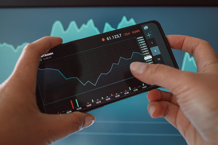 Trader investor discussing and analysis graph on smartphone. Finance application for sell, buy and...