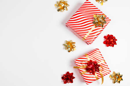 Gift box with gold ribbon on white background. Christmas and New Year holiday background.Festive banner. Top view, flat lay, copy spaceの写真素材