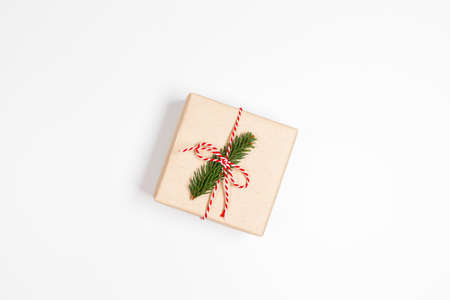 Gift box with red ribbon and fir on white background. Christmas and New Year holiday background. Top view, flat lay, copy spaceの写真素材