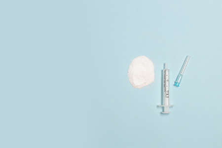 Drugs heroin powder pills and syringes on blue background. Healthy lifestyle concept. International day against drug abuseの写真素材