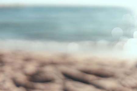 Blur tropical beach with a bokeh sun light wave abstract background.の写真素材