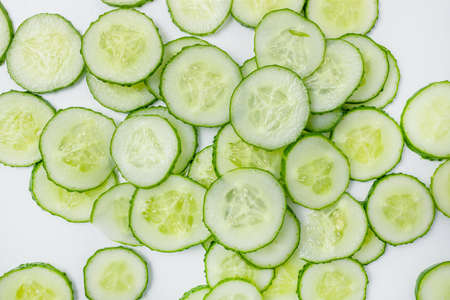 Fresh cucumber with many round slices background.の写真素材