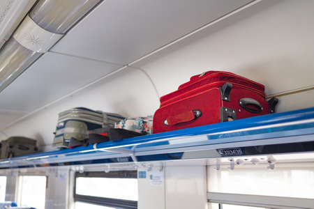 Lots of suitcases and carry-on bags in the luggage compartment of the train. Holiday vacation, tourism, travel, modern train interior, of railway transportation concept.の写真素材
