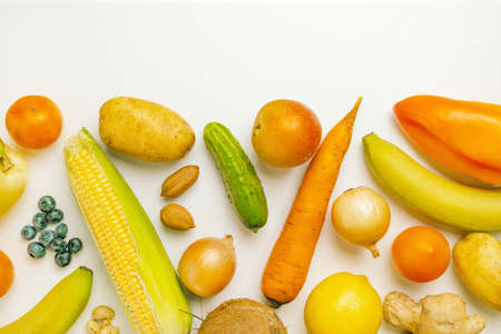 Various healthy fresh vegetables, fruits and nuts on a white background. Balanced diet foodの写真素材