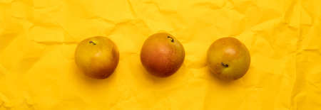 Creative summer pattern made of fresh yellow cherry plums on yellow background. Fruit concept. Flat lay.の写真素材