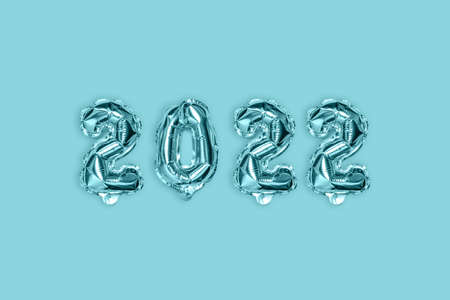 2022 blue silver decoration holiday on blue background. Gold foil balloons numeral. Flat lay, top view.の写真素材