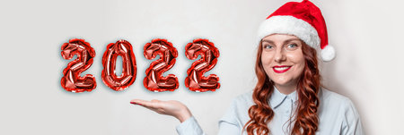 Christmas Eve and New Years Eve. Fun young Caucasian woman and santa hat with expressing happy...