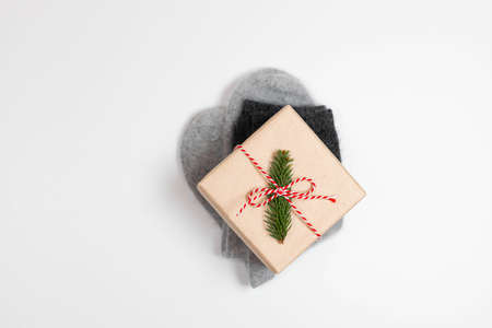 Cozy winter new year and christmas composition. Flat lay of warm socks, fir branches and gift box and candies on a white background. Top view, flat lay, copy spaceの写真素材