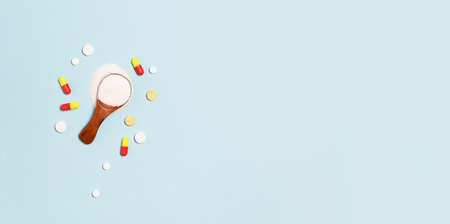 Assorted pharmaceutical medicine pills, tablets and capsules on blue background. Healthcare and medicalの写真素材