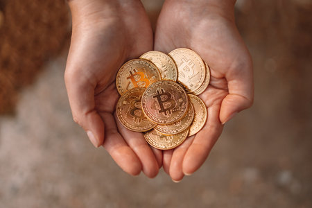 Unrecognizable female hand shows a lot of bitcoin cash coin. Flat lay.の写真素材