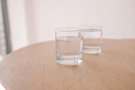 Glass of water on wooden table at modern loft luxury interior cafe. Tasty morning drinks.の写真素材