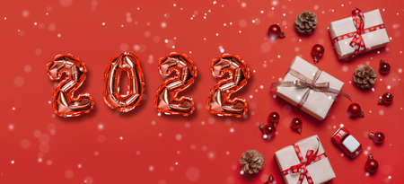 Xmas and Happy new year red 2022 numbers with snowflake, color trendy festive decorations on blue background. Greeting card, Holiday banner, web posterの写真素材