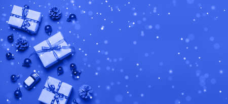 Christmas 2022 banner background with beautiful craft gift box with ribbon, stars, small balls, top view, copy space frame background.の写真素材