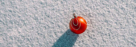 Banner with Christmas red ball decoration on snow background with copy space for text for Christmas wallpaper and advertising, flat layの写真素材