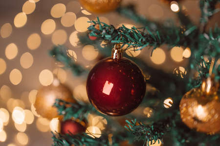 Merry christmas happy new year burgundy color balls with Christmas tree, blurred shiny lights. Close upの写真素材