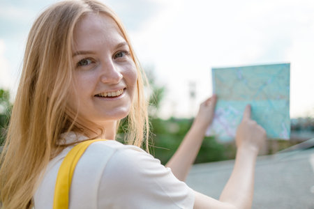 Female tourist traveler with map on city, traveling in Europe. Tourism, destination concept