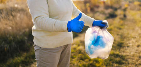 Cleanup volunteer collecting trash in the forest,environmental protection concept. Earth dayの写真素材