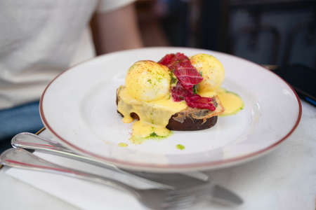 Delicious breakfast with poached egg with tuna and cheese on toast. Healthy food for lunch. close-upの写真素材