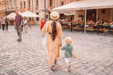 Lviv, Ukraine - July 6, 2021: People tourists walk along the city street on a summer sunny day, on...