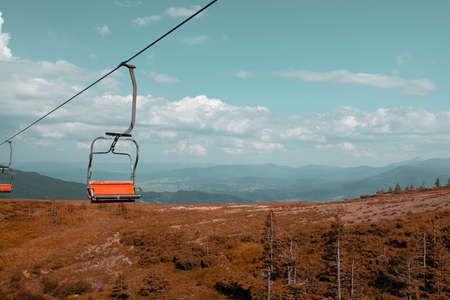 Mountain landscape with cable car and forest. Travel and adventure concept. Funicular on the top of big mountainの写真素材