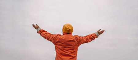 Caucasian woman raising her hands up relax on spring vacation time, carefree girl being in nature,...