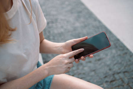 Tourist female using smartphone mobile app to text sms while travelingの写真素材
