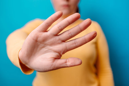 stop war. Woman shows a palm on blue background
