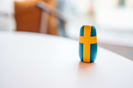 swedish flag wooden toy on white table at cafe.の写真素材