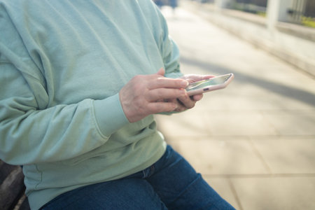 Business woman hands using mobile phone while going to work