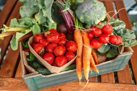 Close-up of fresh vegetables in cardboard box on the table delivered to home.の写真素材