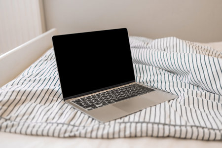 Laptop on the bed. Business at home. Work in the bedroom. Rest in the bed with laptop.