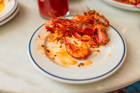 Leftovers from shrimp on a white plate. Close upの写真素材