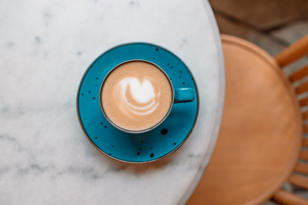 Cup of cappuccino or latte coffee and beautiful heart Latte Art at the hipster coffee shop, Valentines day concept.の写真素材
