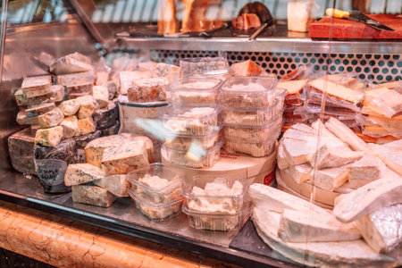 Variety of cheeses on La Boqueria Market. Healthy snack stall full of different dry foods. Diet snacks market. Barcelona, Spainの写真素材