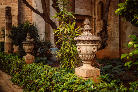 Ancient decorative vases in the garden next old town. Blurred building in the background. Valencia, Spainの写真素材