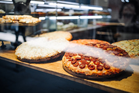 Delicious pizza in the shop window of a small restaurant in Venice, Italyの写真素材