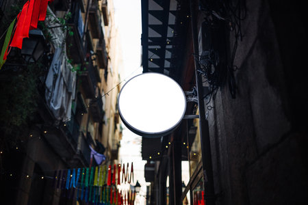 Modern white iron hollow round signboard on the building on the street. Mock up signboardの写真素材