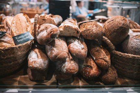 Focus on shelves with bread in a supermarket. Delicious loaves of bread in a german baker shop.の写真素材