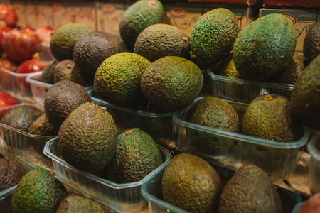 Brown ripe avocados in basket for sale at fruit stall in the market. Barcelona, Spainの写真素材