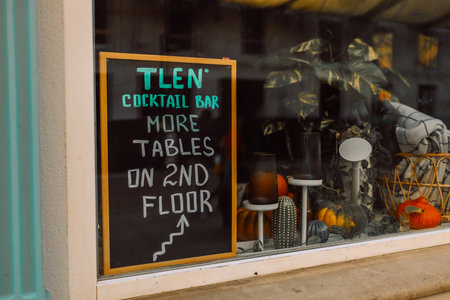 Colorful blackboard cocktail menu with a list of dishes at restaurant with stairs at the background. High quality photoの写真素材