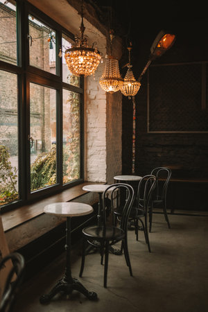 Cafe decoration design with vintage cement wall and window, table and chairs with Modern restaurant...