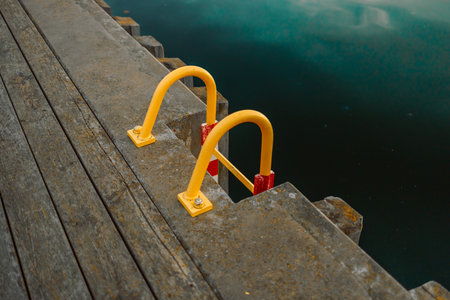 Ladder into the water of the little harbor of the marina of Sopot, Poland, with moored boat and yachts. High quality photoの写真素材